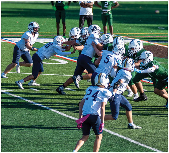 A football player wearing a blue and white uniform. Description generated by AI
