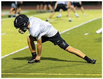 A group of football players on a field. Description generated by AI