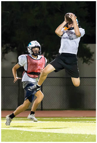 A football game is being played on a field. Description generated by AI