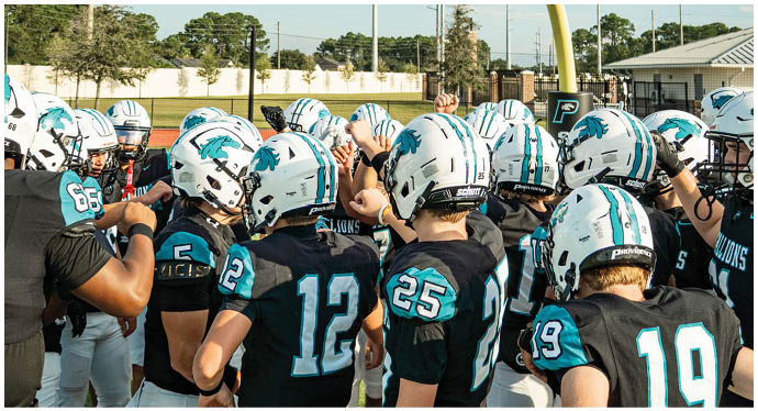 A group of football players on a field. Description generated by AI