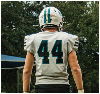 A group of football players on a field. Description generated by AI