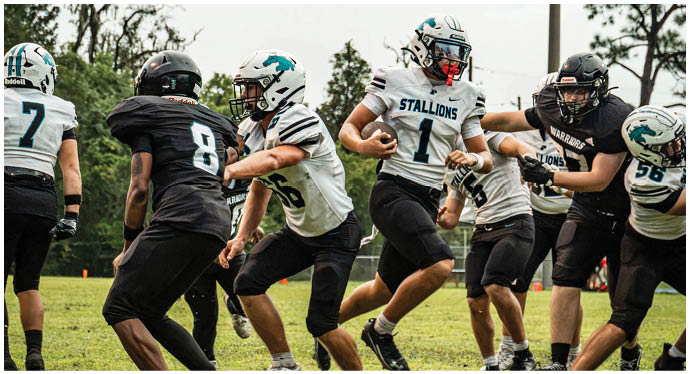 A group of football players on a field. Description generated by AI