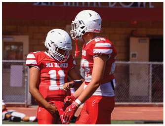 A group of football players on a field. Description generated by AI