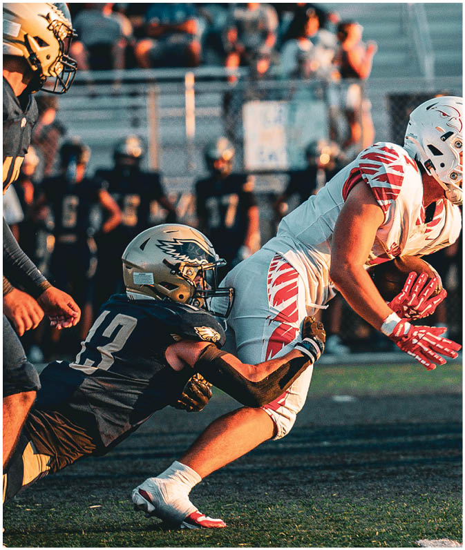 A group of football players on a field. Description generated by AI