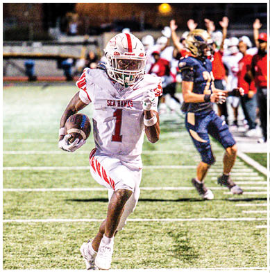 A football player running on the field. Description generated by AI
