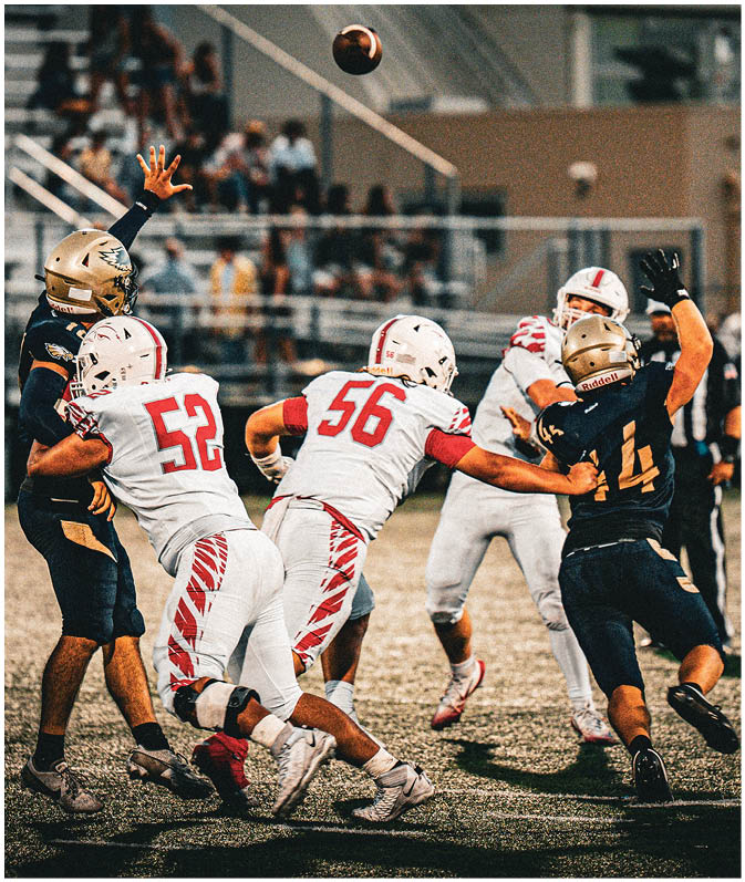 A group of football players on a field. Description generated by AI