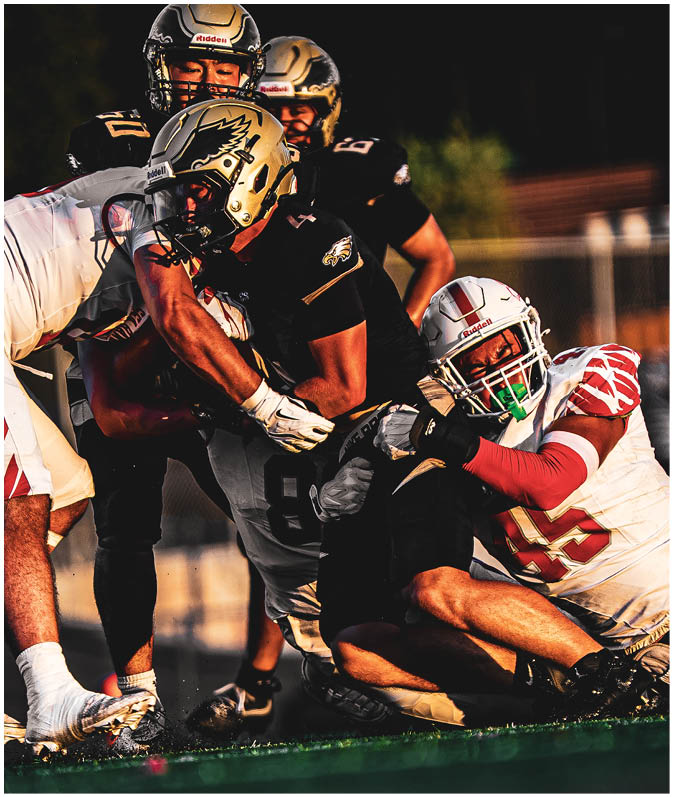 A group of football players on a field. Description generated by AI
