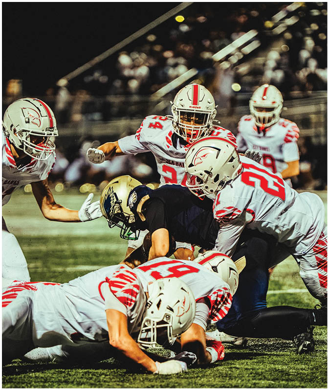 A group of football players on a field. Description generated by AI