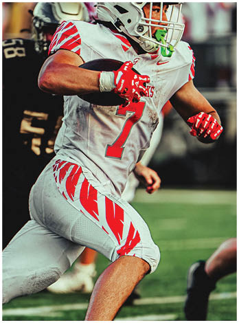 A football player wearing a blue and red jersey. Description generated by AI