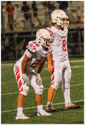 A group of football players celebrating a touchdown. Description generated by AI