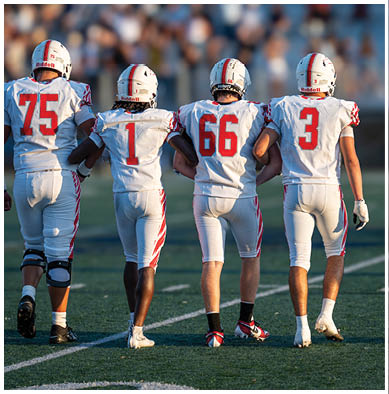 A football player running on the field. Description generated by AI