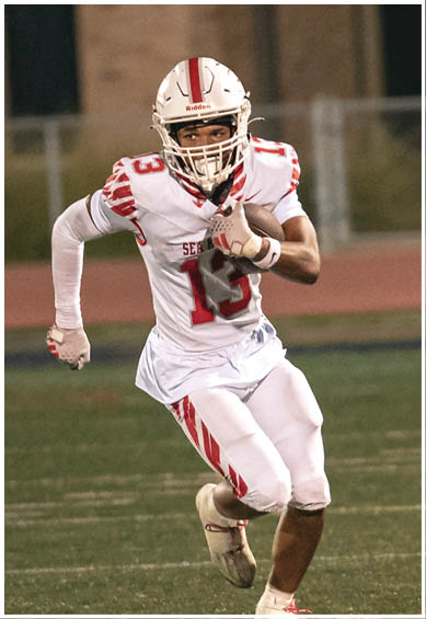 A football player wearing a blue jersey with the number 58 on it. Description generated by AI