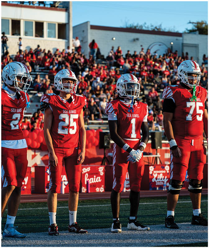 A group of football players on a field. Description generated by AI