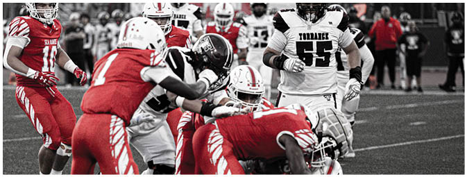 A group of football players on a field. Description generated by AI