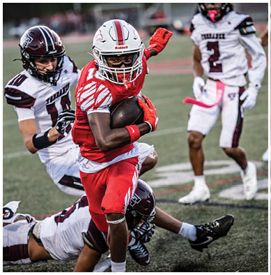 A football player running on the field. Description generated by AI