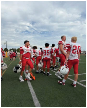 A football game is being played on a field. Description generated by AI