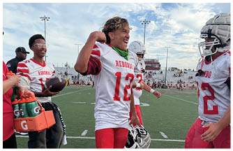 A group of football players on a field. Description generated by AI