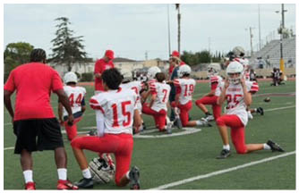 A group of football players on a field. Description generated by AI