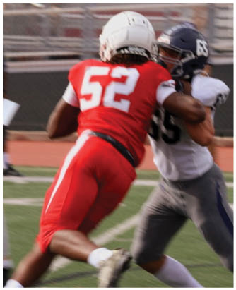 A football player catching a ball. Description generated by AI