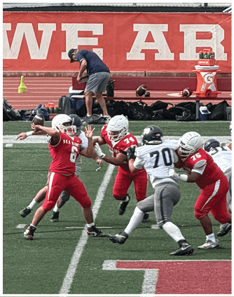 A football game is being played on a field. Description generated by AI