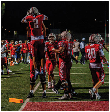 A football player running on the field. Description generated by AI
