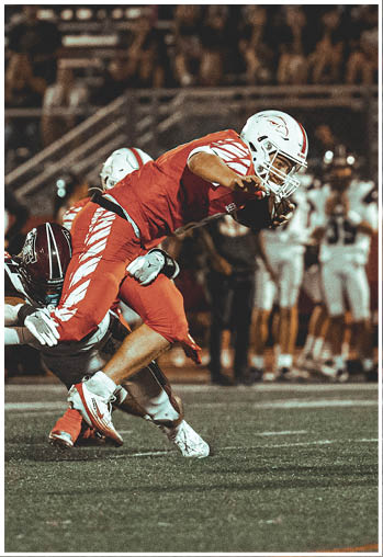 A group of football players celebrating a touchdown. Description generated by AI