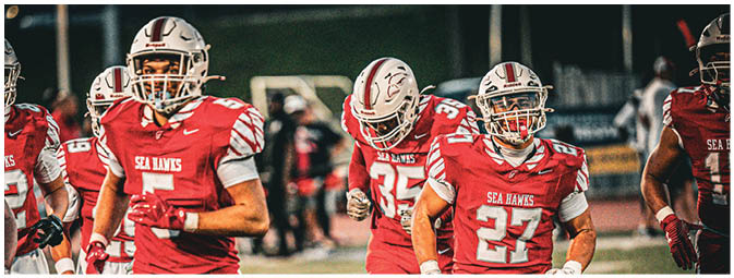 A group of football players on a field. Description generated by AI