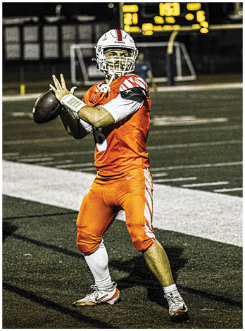 A football player wearing a blue and red jersey. Description generated by AI