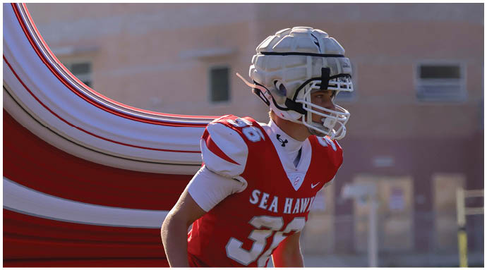 A football player wearing a blue and white uniform. Description generated by AI