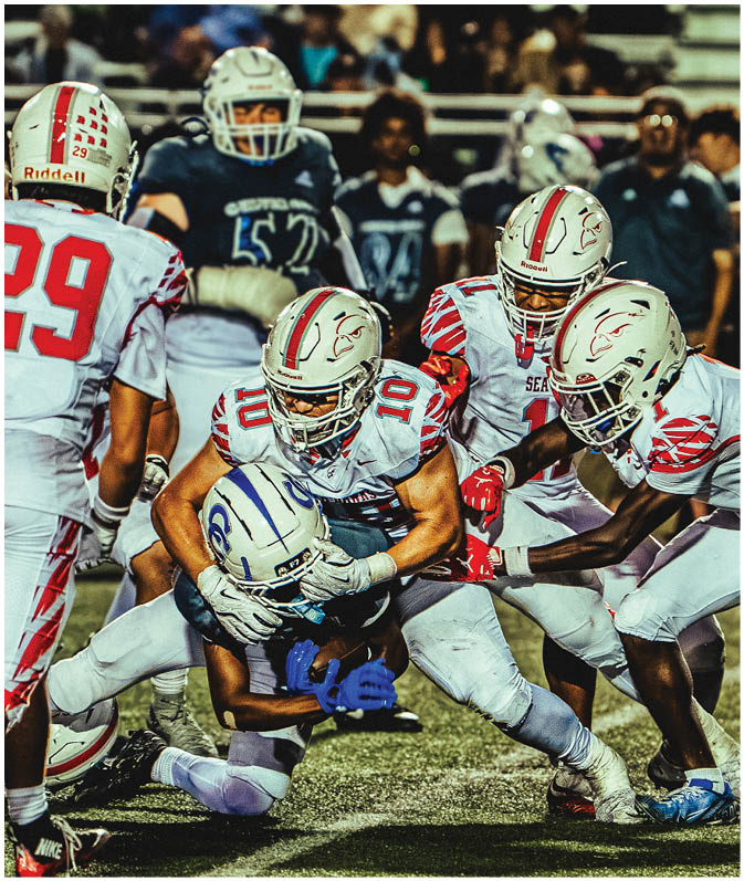 A group of football players on a field. Description generated by AI