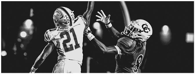 A group of football players on a field. Description generated by AI