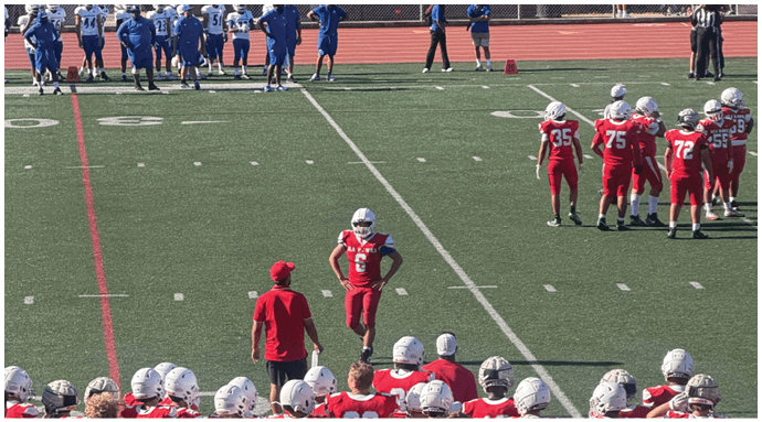 A football player wearing a blue and white uniform. Description generated by AI