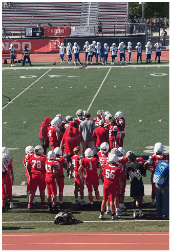 A football game is being played on a field. Description generated by AI