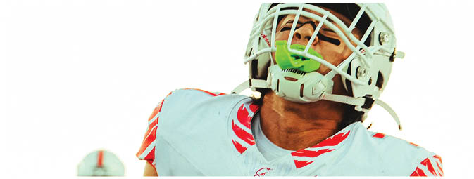 A group of football players on a field. Description generated by AI