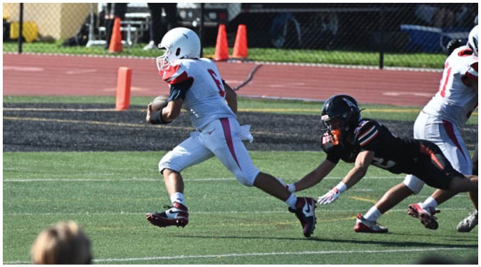 A football player wearing a blue and white uniform. Description generated by AI