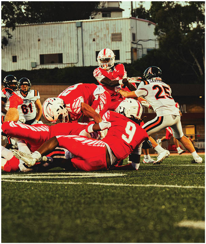 A group of football players on a field. Description generated by AI