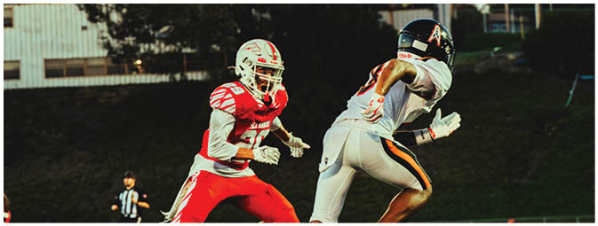 A group of football players on a field. Description generated by AI