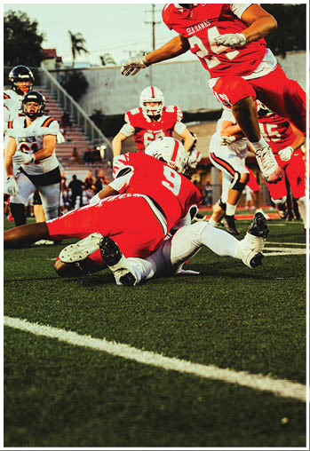 A group of football players celebrating a touchdown. Description generated by AI