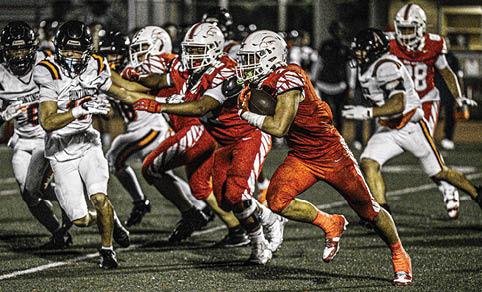 Two men wearing football uniforms are hugging each other on a field. AI generated content