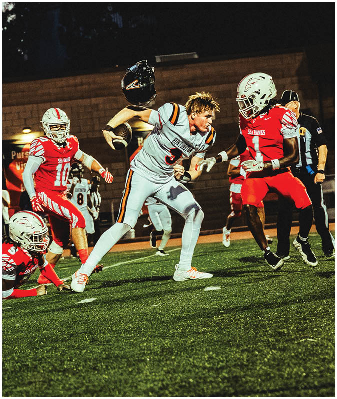 A group of football players on a field. Description generated by AI