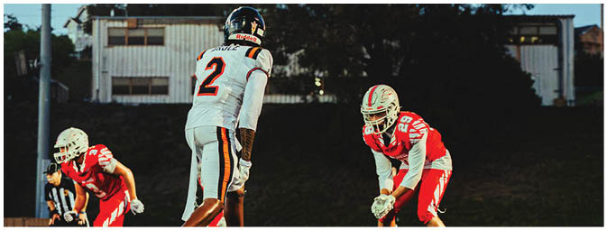 A group of football players on a field. Description generated by AI