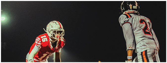 A group of football players on a field. Description generated by AI