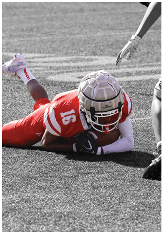 A football player catching a ball. Description generated by AI