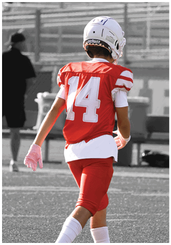 A football player catching a ball. Description generated by AI