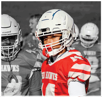 A group of football players on a field. Description generated by AI