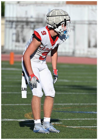 A football player catching a ball. Description generated by AI