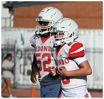 A group of football players on a field. Description generated by AI
