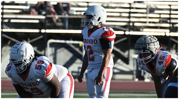 A football player wearing a blue and white uniform. Description generated by AI