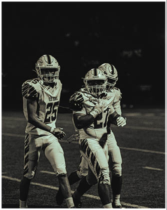 A football game is taking place with a group of men on the field. Description generated by AI