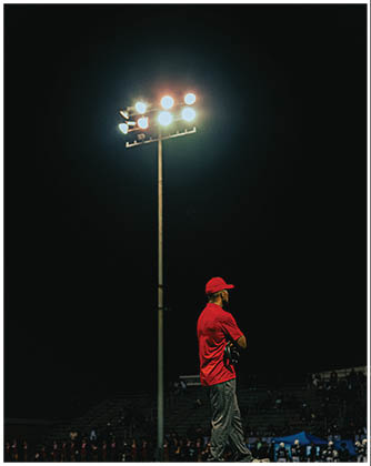A football game is taking place with a group of men on the field. Description generated by AI